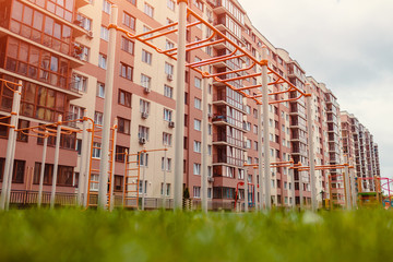 Wall Mural - New multi-storey residential building. Sports ground with lawn in front of the house