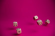 © Denis - dice in fall on magenta background