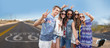 © Syda Productions - travel, technology and road trip concept - smiling young hippie friends taking picture by smartphone on selfie stick and showing peace hand sign over us route 66 background