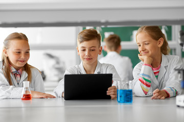 Sticker - education, science and technology concept - kids with tablet pc computer studying chemistry at school laboratory