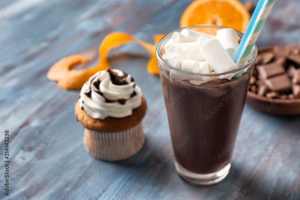 Glass of hot chocolate with marshmallows on wooden table