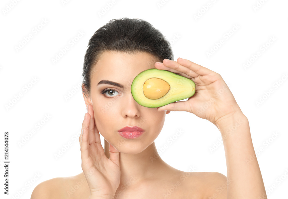 Beautiful young woman with avocado on white background