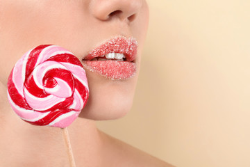 Sticker - Beautiful young woman with creative makeup and lollipop on color background, closeup