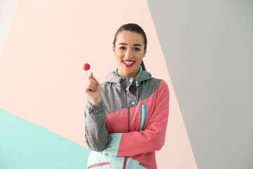 Sticker - Attractive young woman with lollipop on color background