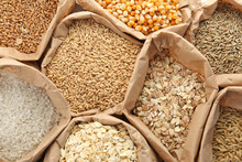 Paper Bags With Different Types Of Grains And Cereals As Background