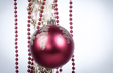 red Christmas ball and Golden garland on white background