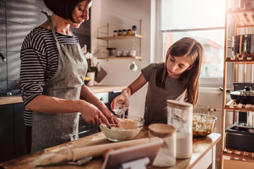 Wall Mural - Mother and daughter making apple pie dough