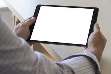 Wall Mural - digital tablet computer close up man using tablet hands man multitasking with isolated screen
