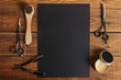 © LIGHTFIELD STUDIOS - top view of professional barber tools and blank black card on wooden table