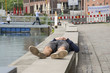 Mittagspause am Hafen  schlafender junger Mann am Rand einer Baustelle