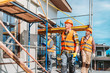 © LIGHTFIELD STUDIOS - group of handsome builders working together at construction site