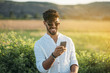© ADDICTIVE STOCK - Cheerful man using smartphone in nature