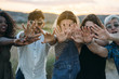 © ADDICTIVE STOCK - Young people reaching out hands in nature