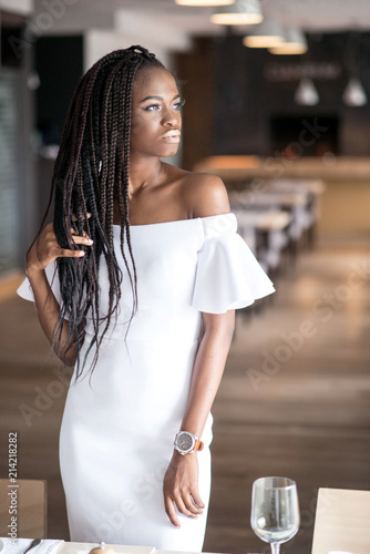 Beautiful African American Girl In A White Dress Posing For