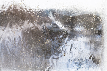 Wall Mural - unfocused view of village through frozen window