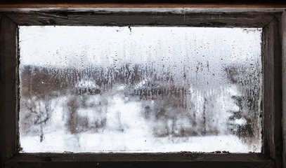 Wall Mural - water drops from melting snow on frozen window