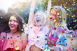 © Westend61 - Three women having fun with holi powder and confetti