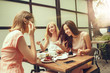 © master1305 - Two girl friends spend time together drinking coffee in the cafe, having breakfast and dessert.