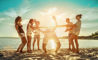 Happiness Friends funny game on the beach under sunset sunlight