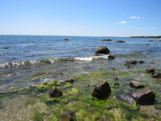 A beautiful rocky beach on a sunny day with blue sky 