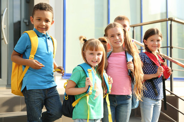 Sticker - Cute little children with backpacks outdoors. Elementary school