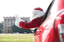 Authentic Santa Claus Leaning Out Of Car Window, View From Outside
