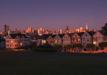 San Francisco California. Famous Houses Called Painted Ladies And View Of The City, During The Sunset And The First Lights Of The Night