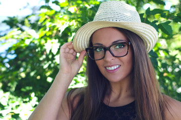 young woman holding hat glasses summer holiday attractive people smiling portrait