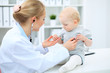 © rogerphoto - Doctor and patient in hospital. Little girl is being examined by pediatrician with stethoscope. Medicine and health care