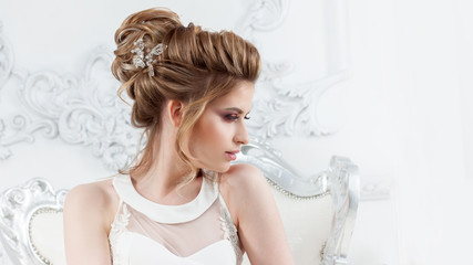 Wedding style. Beautiful young bride with luxury wedding hairstyle