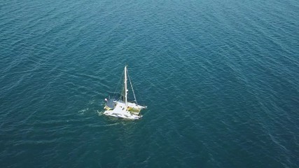 Poster - aerial top view from above of large sailing catamaran in the open sea isolated