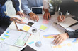© Prathankarnpap - Business meeting with paper chart and laptop computer tablet on table,Consult concept.