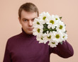 © Vladimir Arndt - Young man with white flowers in his hand.