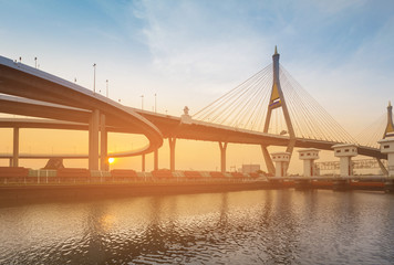 Wall Mural - Sunset over highway and suspension bridge river front