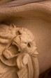 © nowyn - Stone carving of he head of a lion snarling worked in white stone and a direct view into the open jaw