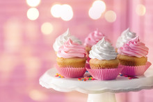 Dessert Stand With Delicious Cupcakes On Blurred Background