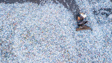 Aerial Top View  Large Garbage Bottle Pile Background, Garbage Pile In Trash Dump, Waste From Household, Bottle Waste Disposal In Dumping Site, Excavator Machine Is Working On A Mountain Garbage.