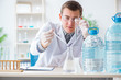 © Elnur - Young chemist student experimenting in lab