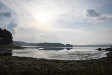 Wall Mural - Misty morning on a lake. Sunrise on a shore on the lake