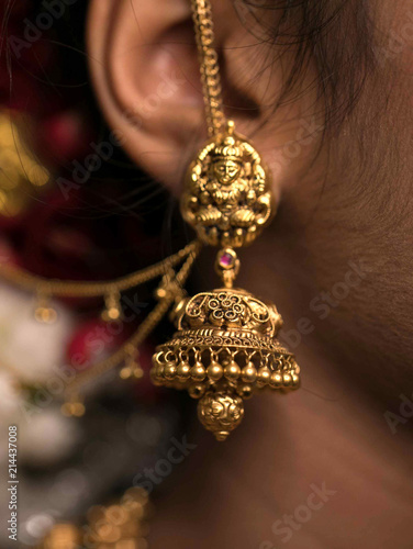 Closeup Of Golden Ear Hanging Jewelry Hair Do And Flower
