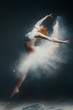 © Monstar Studio - Dancing in flour concept. Redhead beauty female girl adult woman dancer in dust fog. Girl wearing white top and shorts making dance element in flour cloud in form of skirt on isolated grey background