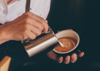 Wall Mural - close up barista hand making a cup of coffee.