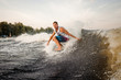 © fesenko - Young active man riding on the wakeboard on the open air