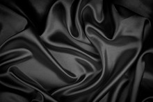 Black Silk Texture Luxurious Satin For Abstract Background. Fabric Of Dark Tone
