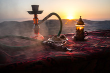 Hookah Hot Coals On Shisha Bowl Making Clouds Of Steam At Desert Outdoor. Oriental Ornament On The Carpet Eastern Tea Ceremony. Stylish Oriental Shisha On Sunset Background.