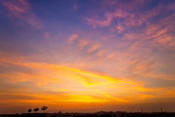 Wall Mural - sunset / sun rise sky with rays of yellow and red light shining clouds and sky background and textur