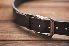 Leather Belt On A Wooden Table