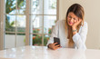 © Krakenimages.com - Depressed and sad woman crying using smartphone at home