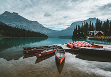 Red Kayaks Dry Upside Down. Emerald Lake In Canadian Rockies With Mountains And Trees And Refelction. Concept Of Active Vacation And Tourism