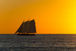 USA, Florida, Burning orange sky after sunset with majestic sailboat on the water